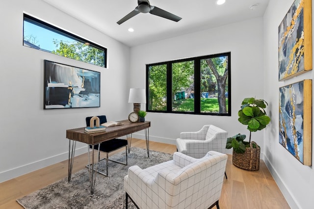 office space with light wood-type flooring and ceiling fan