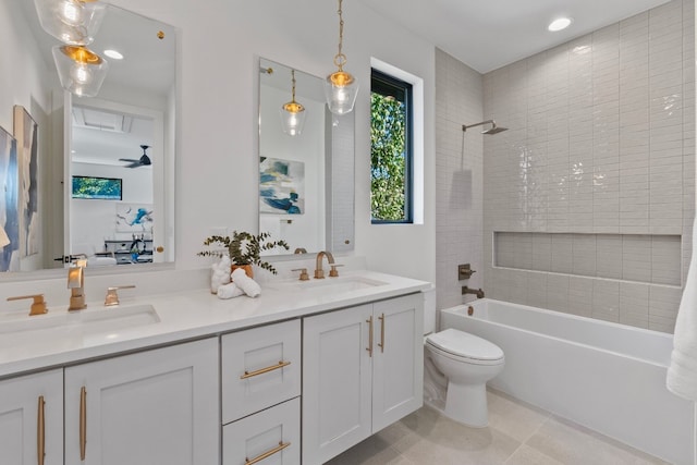 full bathroom with ceiling fan, vanity, tiled shower / bath combo, tile patterned flooring, and toilet