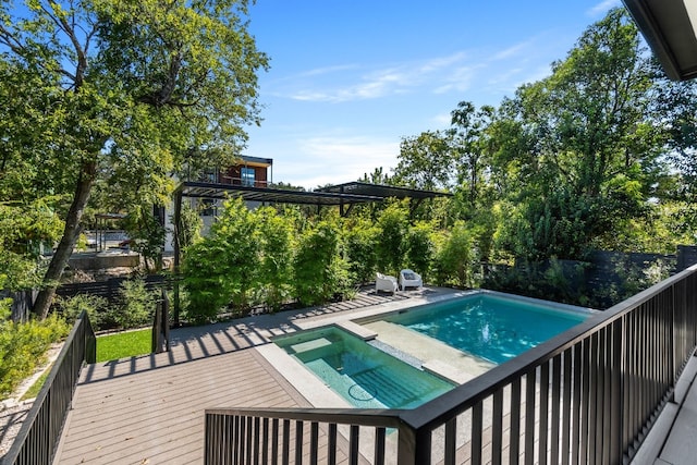 view of swimming pool featuring an in ground hot tub and a wooden deck