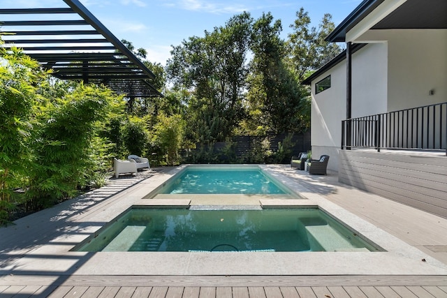 view of swimming pool with an in ground hot tub and a patio area