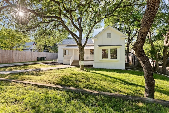 rear view of property with a lawn