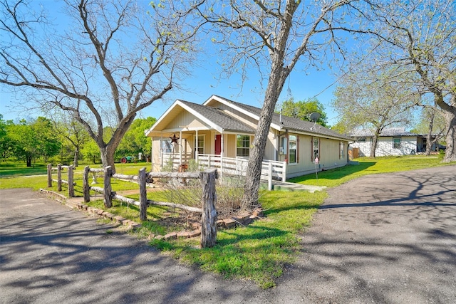 view of front of property with a porch and a front lawn