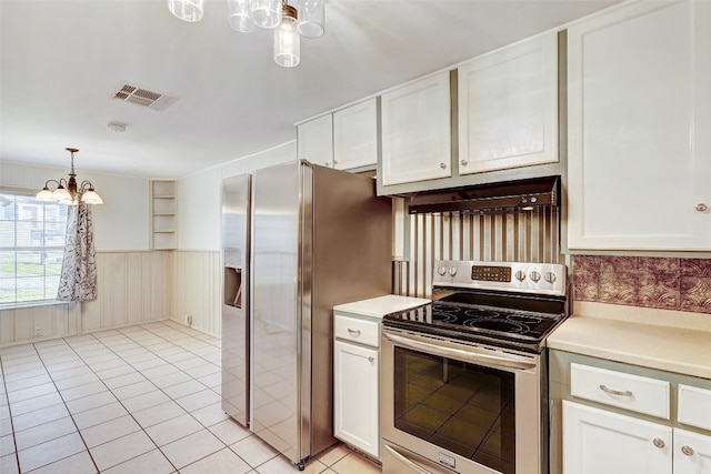 kitchen featuring appliances with stainless steel finishes, hanging light fixtures, light tile flooring, a chandelier, and white cabinets