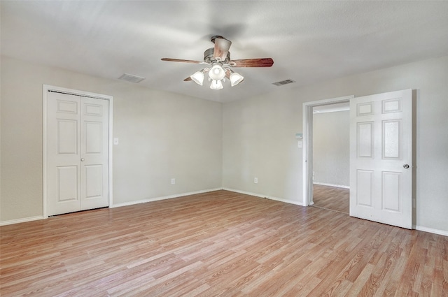 empty room featuring ceiling fan and light wood-type flooring