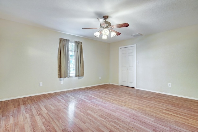 unfurnished room with ceiling fan and light wood-type flooring