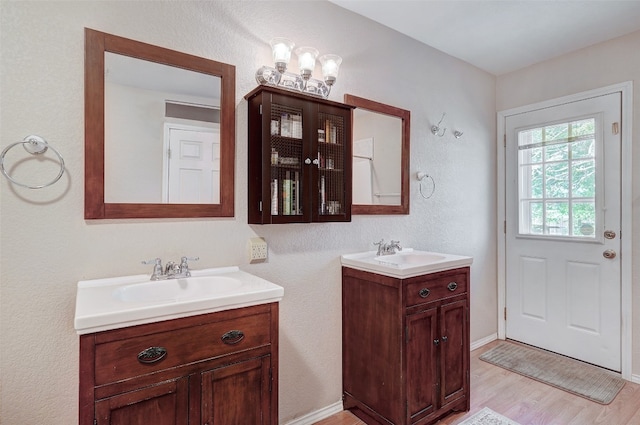 bathroom featuring double sink, large vanity, and hardwood / wood-style flooring