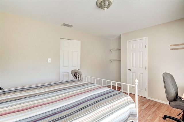 unfurnished bedroom with a closet and light wood-type flooring