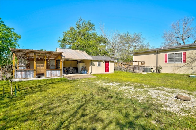 view of yard with central AC and a patio