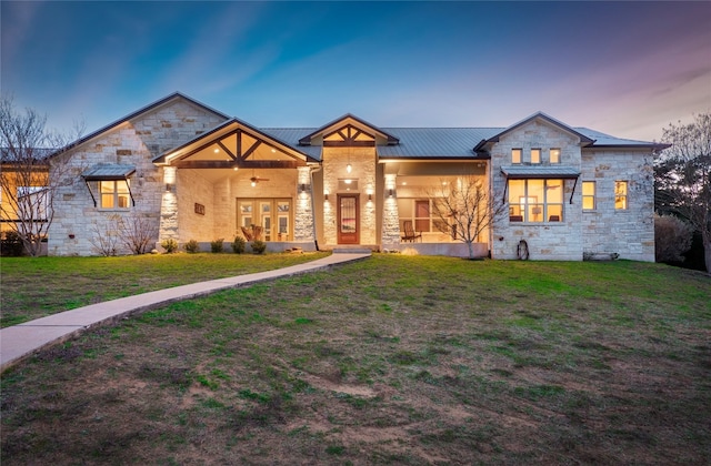 view of front of property with a yard and french doors