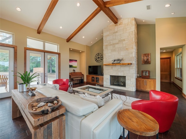 living room with high vaulted ceiling, dark hardwood / wood-style floors, and a wealth of natural light