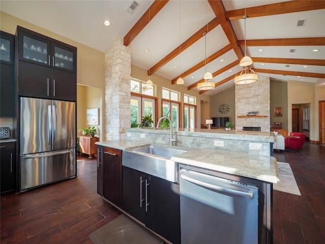 kitchen with pendant lighting, a center island with sink, appliances with stainless steel finishes, dark hardwood / wood-style flooring, and sink