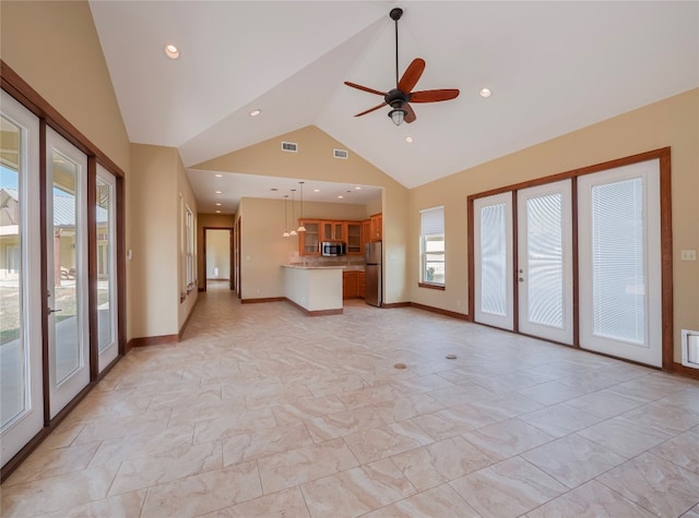 unfurnished living room featuring ceiling fan, light tile flooring, and high vaulted ceiling