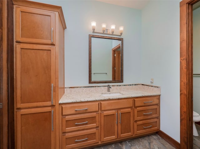 bathroom with vanity, hardwood / wood-style floors, and toilet