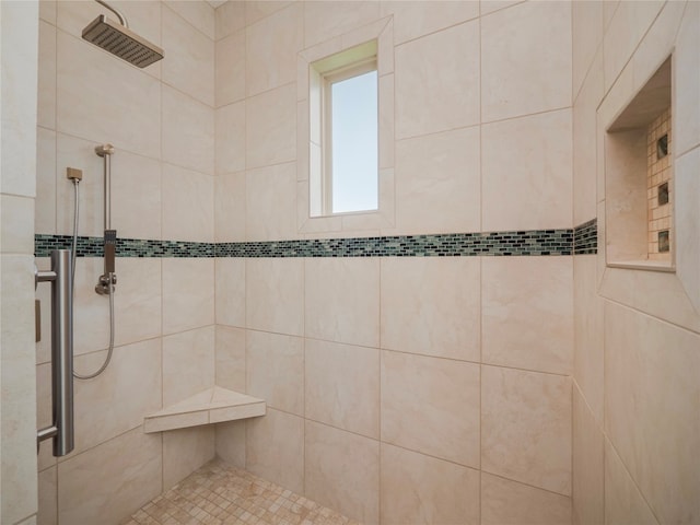 bathroom with a tile shower