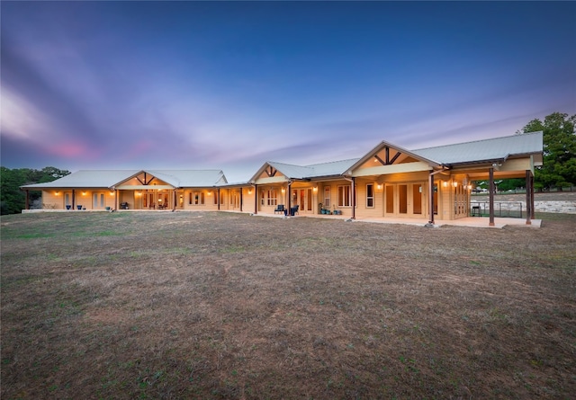 back house at dusk with a yard