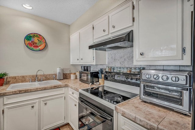 kitchen with a textured ceiling, white cabinetry, black appliances, and sink