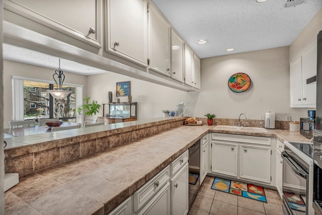 kitchen with hanging light fixtures, white cabinets, black appliances, and sink