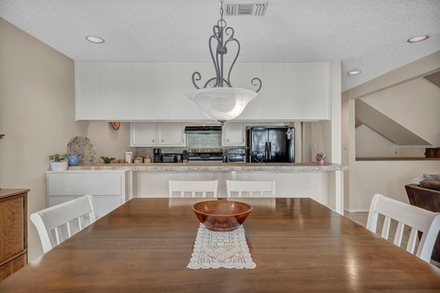 dining space featuring a textured ceiling