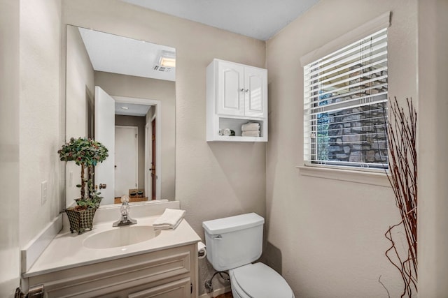 bathroom with toilet and vanity