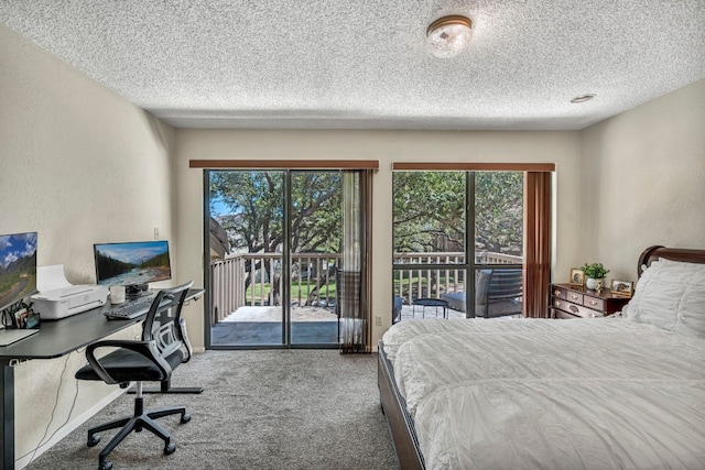 carpeted bedroom featuring access to outside and a textured ceiling