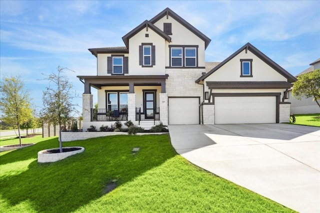 view of front facade with a porch, a garage, and a front lawn