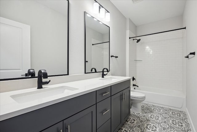 full bathroom with double vanity, a sink, toilet, and tile patterned floors