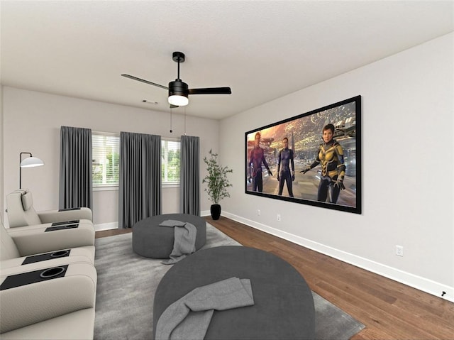 cinema with visible vents, ceiling fan, baseboards, and wood finished floors