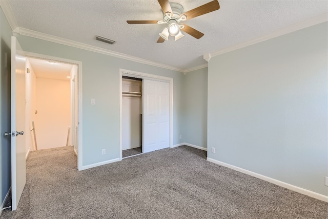 unfurnished bedroom featuring a textured ceiling, ceiling fan, a closet, and carpet floors