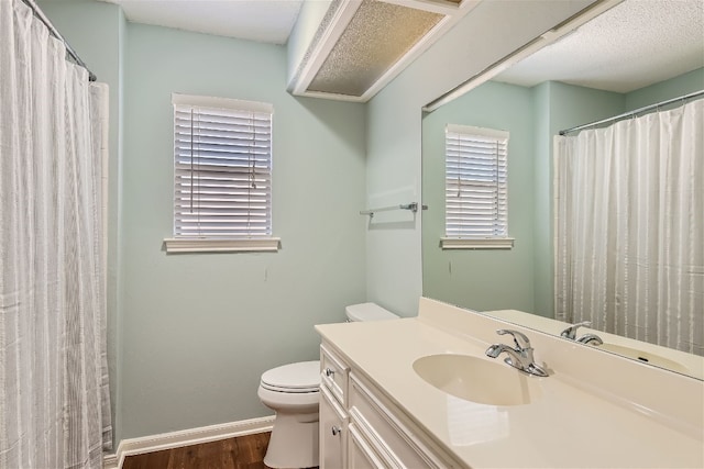 bathroom with vanity, toilet, and wood-type flooring