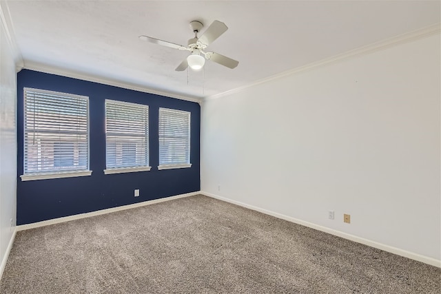 empty room featuring ceiling fan, crown molding, and carpet floors