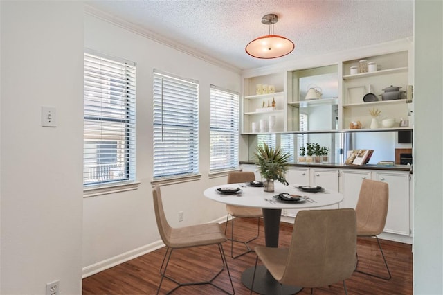 dining room with a healthy amount of sunlight, wood-type flooring, and a textured ceiling