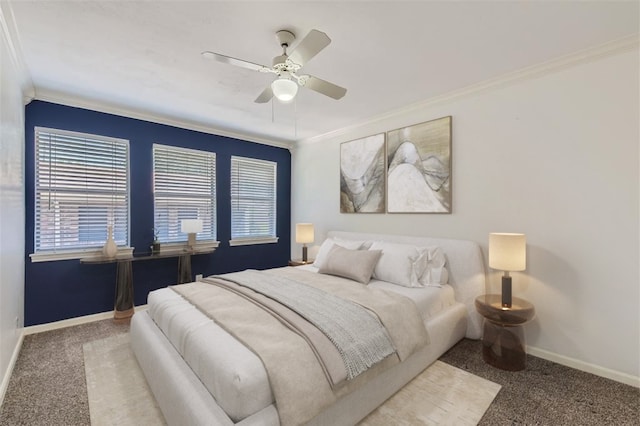 bedroom with crown molding, ceiling fan, and carpet floors