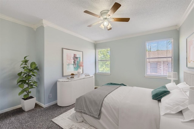 bedroom with ceiling fan, carpet floors, crown molding, and a textured ceiling