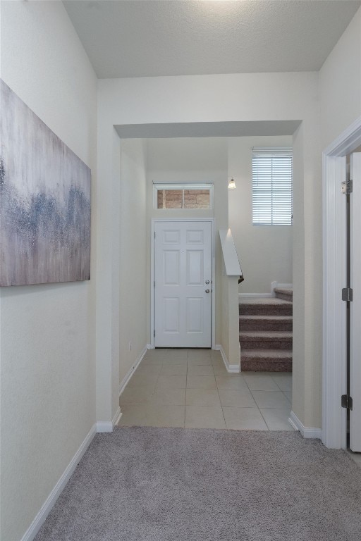 view of carpeted foyer