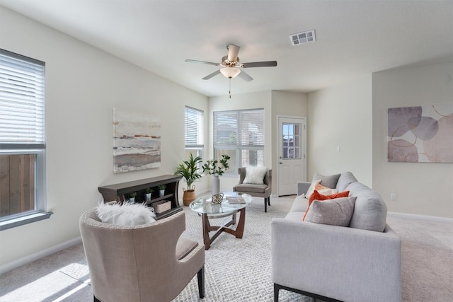 living room featuring light carpet and ceiling fan