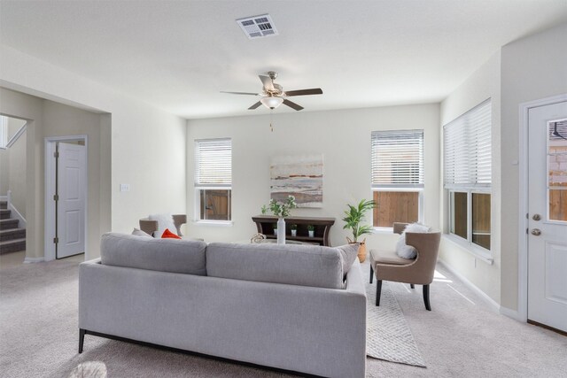 living room featuring ceiling fan and light colored carpet