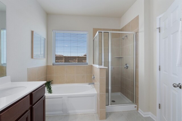 bathroom featuring independent shower and bath, tile floors, and vanity