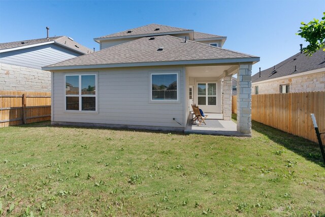 rear view of property with a lawn and a patio area