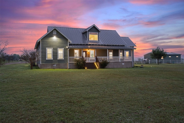 view of front of home featuring a lawn and covered porch