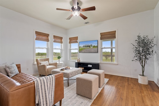 living room featuring light wood-type flooring and ceiling fan