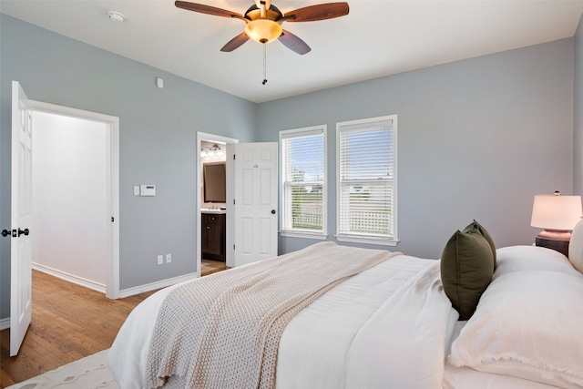 bedroom featuring ceiling fan, connected bathroom, and light hardwood / wood-style floors