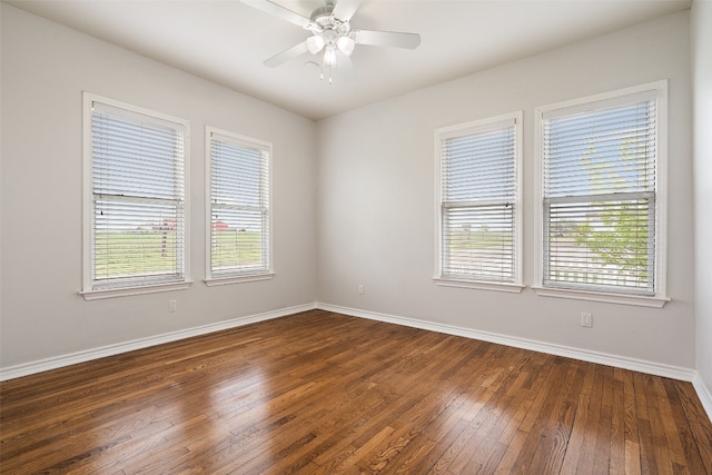 unfurnished room with ceiling fan and dark hardwood / wood-style floors