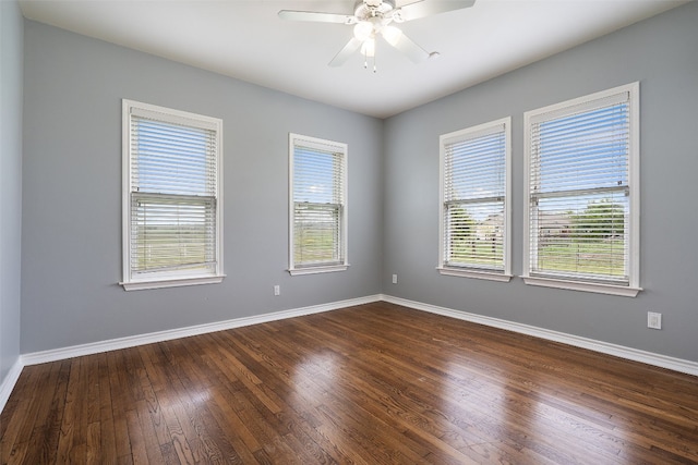 unfurnished room with dark wood-type flooring, a healthy amount of sunlight, and ceiling fan