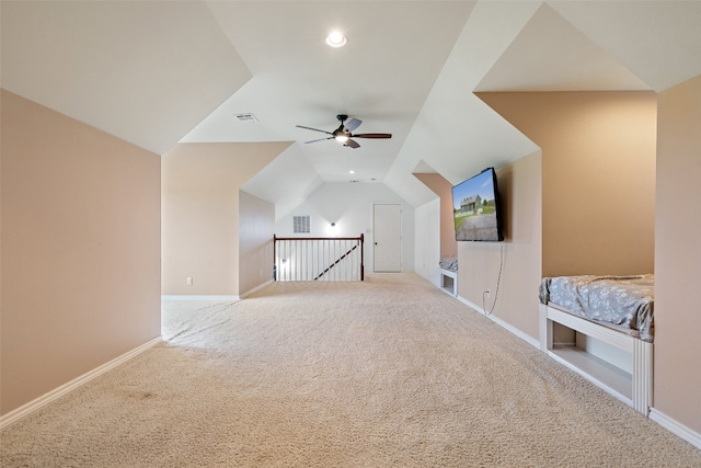 additional living space with ceiling fan, carpet, and vaulted ceiling