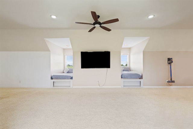 additional living space featuring carpet flooring, ceiling fan, and a fireplace