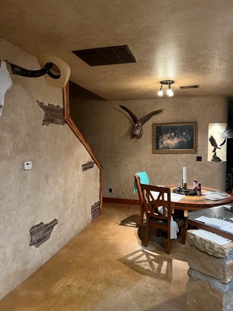 409 County Road 138th Rd, Burnet, TX 78611 - dining room with unfinished concrete floors, a textured ceiling, and visible vents