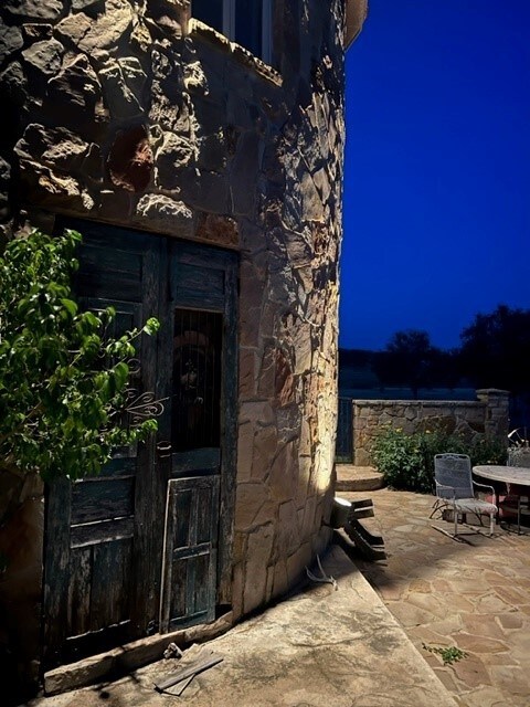 409 County Road 138th Rd, Burnet, TX 78611 - doorway to property with stone siding and a patio