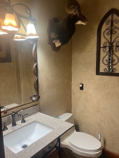 409 County Road 138th Rd, Burnet, TX 78611 - half bath featuring a textured wall, toilet, and vanity