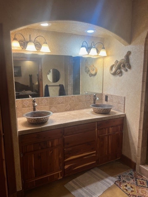 409 County Road 138th Rd, Burnet, TX 78611 - full bathroom featuring ensuite bathroom, double vanity, a sink, and tasteful backsplash