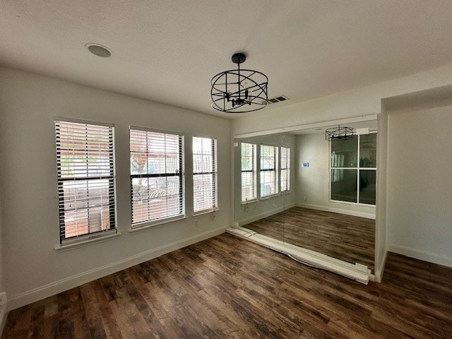 interior space featuring a notable chandelier, dark hardwood / wood-style flooring, and a wealth of natural light